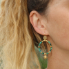 Boucles d'oreilles lumineuses dorées et vertes avec un pendentif étoilé. Origine France Garantie.