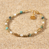 Bracelet doré perles de rivières et pierres turquoises
