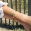 Le bracelet Femme est un bracelet doré unique. Composé de boules en métal doré d'un flash d'or 24 carats, d'une perle de rivière et d'un coeur en métal doré.