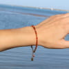 bracelet Clémentine doré et orange porté au poignet en extérieur