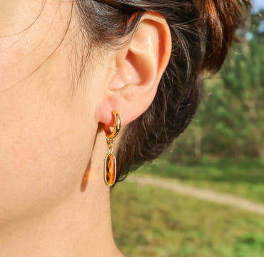 Boucles Galante dorées avec perles marron, portées sur peau dorée – création artisanale française