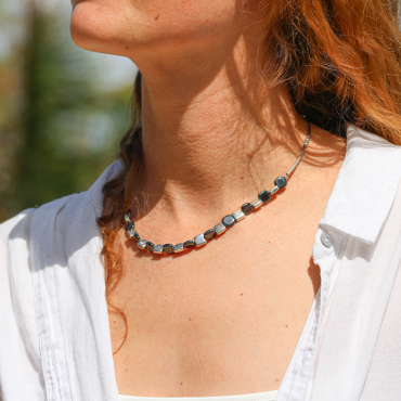 Collier mosaik argenté et gris en hématite porté.
