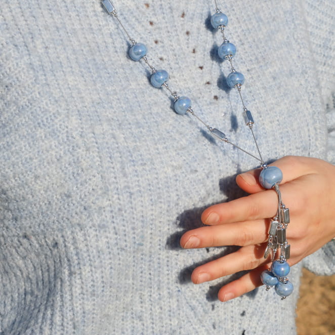Sautoir Seiche porté sur pull bleu clair, bijou artisanal fabriqué en France