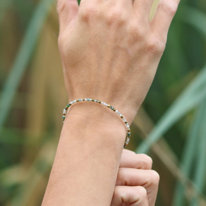 Bracelet Nuja doré à l’or fin et perles vertes, bijou artisanal français inspiré de la nature.