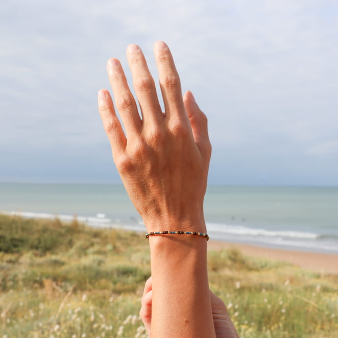 Bijou Ramses doré et perles multicolores, création française inspirée du soleil couchant.