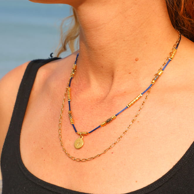 Bijou Sourpi doré à l’or fin et perle bleu marine, création française au style marin chic.