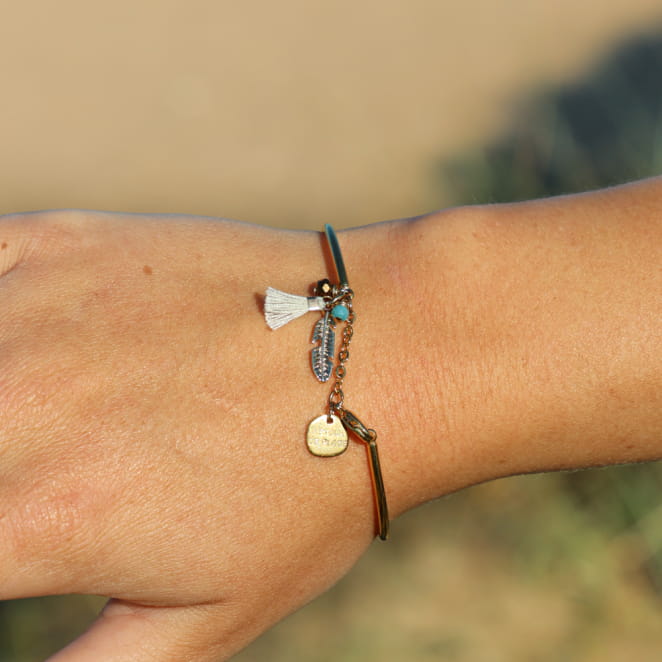 Bracelet jonc Retour de Plage en métal doré 24 carats, orné d'une perle émaillée, d'un pompon beige en coton et de perles en verre – bijou artisanal fabriqué en France