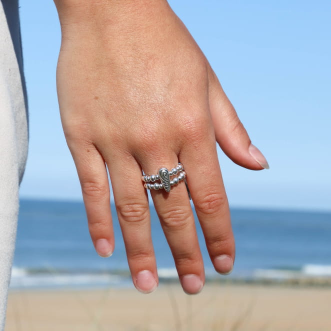 Bague Mandy Retour de Plage en perles métalliques argentées, montée sur élastique transparent, avec perle goutte gravée au centre – bijou artisanal fabriqué en France