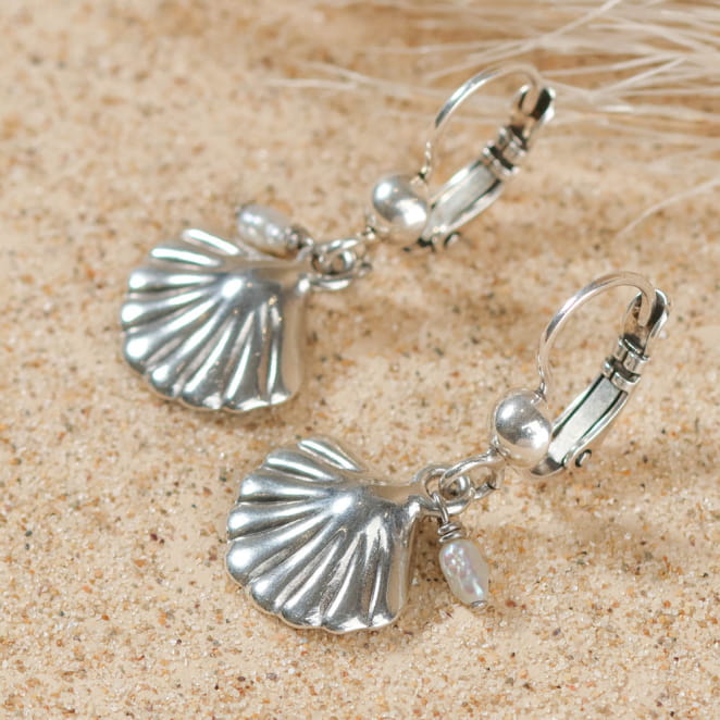 Zoom sur boucles d’oreilles Playa argentées, posées sur le sable – création artisanale française