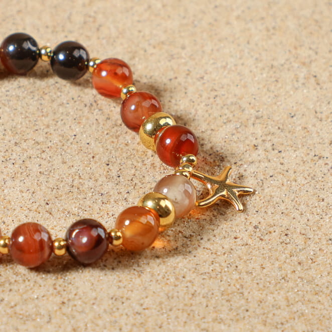 Bijou Culcita doré et perles terracotta, fabrication française au charme solaire