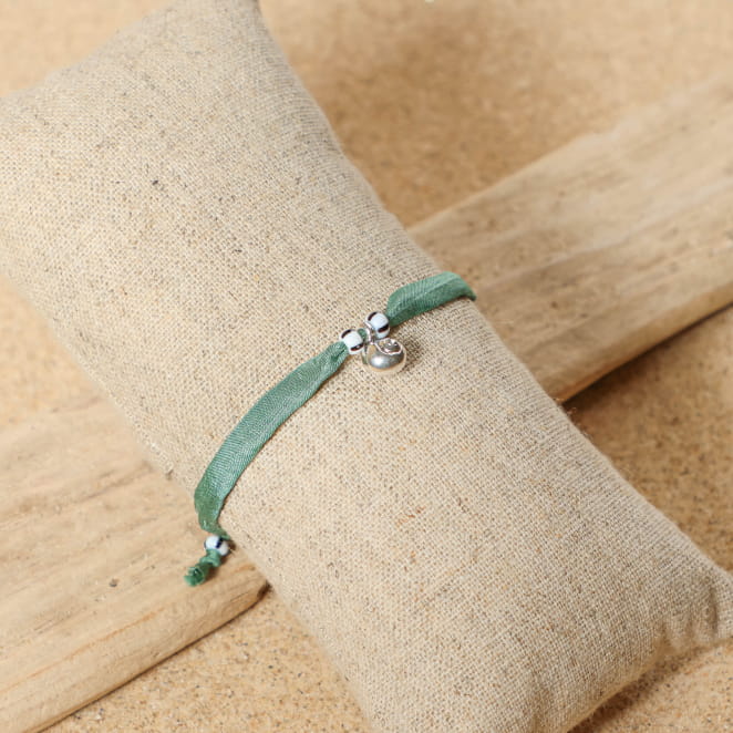 bracelet Friendly argenté avec cordon vert d’eau sur support sable clair